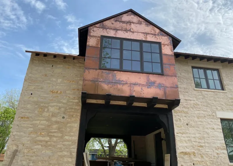 Copper metal panel facade on a stone building for Roof Repair in Twentynine Palms